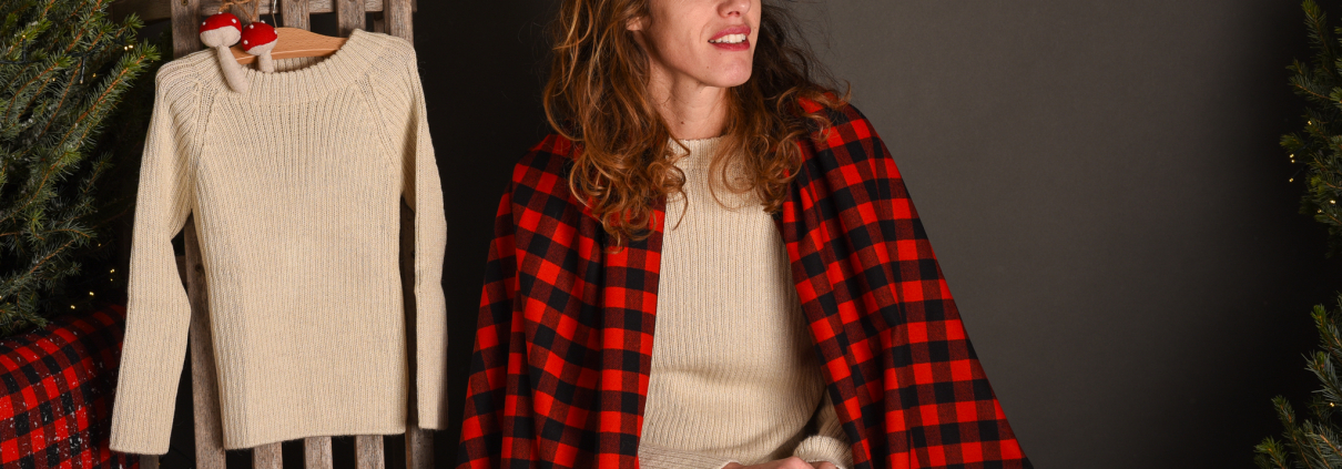 a woman wearing alpaca clothing and choosing beautiful winter outfits for children