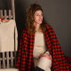 a woman wearing alpaca clothing and choosing beautiful winter outfits for children